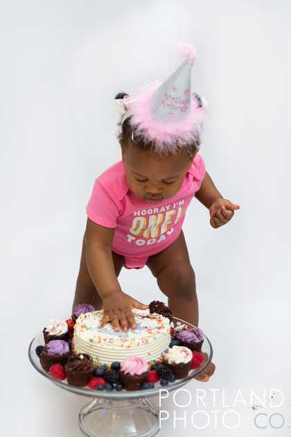 Maine Family Photographer, Baby in birthday hat, pink backdrop, one year old, cake smash